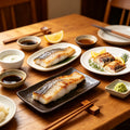 Sushi-style mackerel fillets on crushed ice with shiso and a pink flower